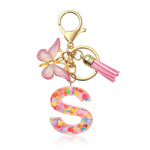 HASTHIP® Llavero Letra S para niñas con mariposa rosa, resina transparente con lentejuelas, colgante metálico elegante para bolso, mochila o llaves, regalo bonito y personalizado